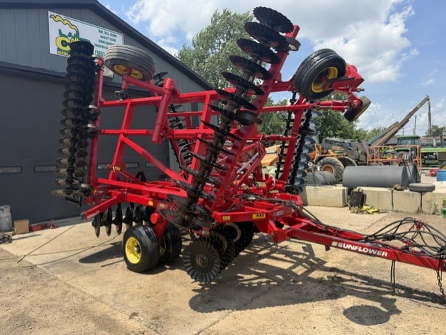 Portable conveyor belt beside tractor salvage equipment